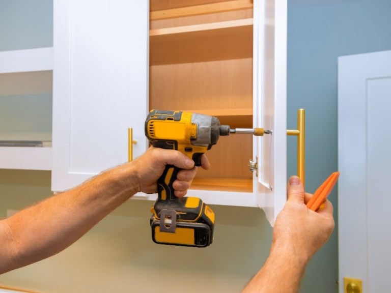 Professional installation of modern gold hardware on custom Amish cabinets for general contractors and interior designers in Central Illinois.